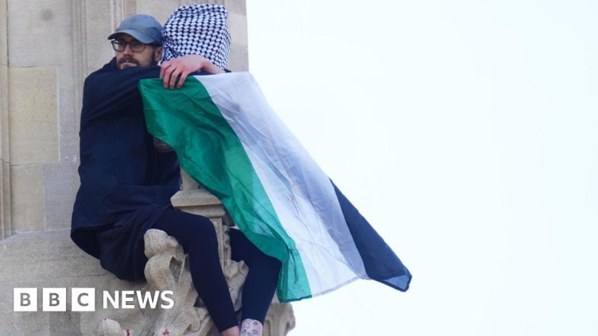 Man holding Palestinian flag still on Big Ben tower